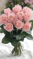 Elegant bouquet of soft pink roses with green leaves tied together, perfect for romantic occasions, celebrations, and floral design projects.