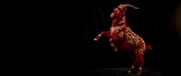 Majestic red dragon creature rearing up on hind legs against dark background, fantasy beast with scales and horns for gaming and storytelling projects.