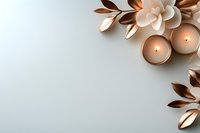 Spa and wellness flat lay with lit candles, decorative metallic leaves, and cream flowers on white background for relaxation and self-care design.