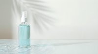 Turquoise liquid in clear glass bottle with spray pump on marble surface, natural light with shadow overlay, sanitizer or cosmetic product mockup for branding and packaging design.