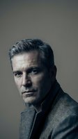 Mature Caucasian businessman with gray hair in wool jacket portrait against neutral background for corporate and professional marketing materials.