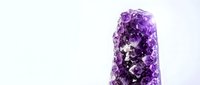 Natural amethyst crystal cluster with vibrant purple gemstone formation on clean white background, isolated for spiritual healing and jewelry design.