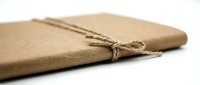 Kraft paper envelope tied with natural twine string, isolated on white background, ready for packaging design, branding, and shipping mockups.