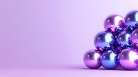 Shiny metallic purple and blue Christmas baubles arranged in pyramid shape on purple background with copy space for festive holiday designs.