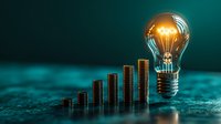 Glowing lightbulb floating above ascending stacks of coins against turquoise background, representing financial growth, investment success and innovative business solutions.