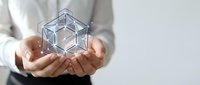 Hands holding glowing geometric wireframe cube with digital network connections for technology and innovation concepts in business presentations.