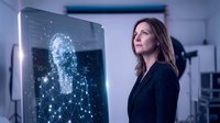 Professional businesswoman analyzing digital security hologram with network connections and data visualization in modern technology office environment.