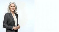 Middle-aged woman with shoulder-length blonde hair, fair complexion, wearing professional black blazer over white shirt. Corporate business portrait suitable for websites, presentations, and corporate materials.