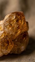 Rough amber crystal specimen with translucent golden-brown facets and natural texture, suitable for geology, mineralogy, jewelry design, and educational materials.