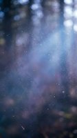 Abstract blurred bokeh background with sparkling lights and cosmic colors in blue purple tones for dreamy atmospheric design projects.