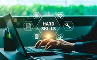 Professional businessman typing on laptop with hard skills technology icons overlay representing technical expertise and digital competencies.