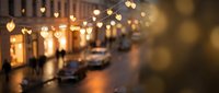 Blurred city street at night with warm golden bokeh heart-shaped lights creating romantic atmosphere for Valentine's Day celebrations and urban nightlife.