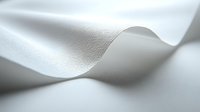 Elegant white fabric with soft waves and gentle folds creating subtle shadows and highlights on textured surface. Minimalist composition for luxury design projects.