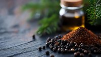 Ground coffee and black peppercorns on dark stone background with glass jar and pine branches, moody food photography for cafe and restaurant menus.