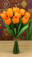 Vibrant orange tulip bouquet with fresh green stems tied with rustic twine, displayed against ornate patterned background on wooden surface.