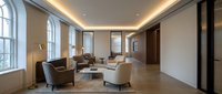 Modern luxury living room interior with beige furniture, marble floors, and ambient ceiling lighting for contemporary home design projects.