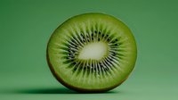 Fresh kiwi fruit slice showing seeds and pulp on green background for healthy eating and nutrition concepts.