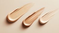 Luxurious foundation cream smears in nude beige tones on light background showing cosmetic texture and consistency for beauty and makeup industry use.