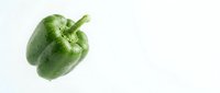 Fresh green bell pepper with water droplets isolated on white background, suitable for food and culinary design projects.