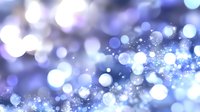 Dreamy blue bokeh background with sparkling light particles creating an ethereal atmosphere for festive designs and holiday themes.