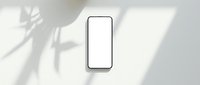 Modern smartphone with blank white screen mockup on neutral background with natural plant shadow overlay for app presentation and digital design projects.