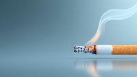 Burning cigarette with rising smoke trail on reflective surface against blue background, illustrating smoking health risks and addiction concept.
