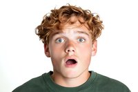 Young man with curly ginger hair and bright blue eyes expressing shock and surprise with open mouth against white background, wearing green casual sweatshirt.