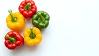 Fresh colorful bell peppers red yellow green isolated on white background for healthy cooking recipes and organic vegetable designs.