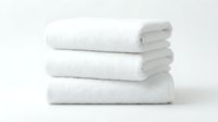 Stack of three fluffy white cotton towels neatly folded on a white background, evoking cleanliness, luxury spa, and hotel comfort.