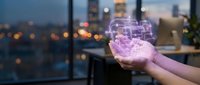 Young woman holding glowing holographic digital interface with city skyline at dusk, representing technology innovation and future business solutions for corporate presentations.