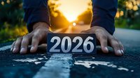 African American hands placing number 2026 on asphalt road against golden sunset background, symbolizing future path, goals and aspirations for coming year.