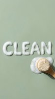 Soap bubbles form the word clean on sage green background with wooden brush and foam, representing hygiene and cleaning products for household and personal care marketing.