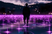Silhouette of person standing on reflective surface with glowing purple lights creating magical atmosphere against dramatic twilight sky and mountain backdrop.