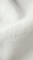 White cotton fabric texture with soft folds and weave pattern for textile design and fashion backgrounds.