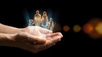 Glowing family figures floating above protective cupped hands against dark background with warm bokeh lights symbolizing care and security.