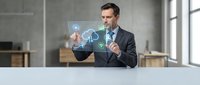 Professional businessman in suit interacting with holographic digital interface displaying charts and data analytics in modern office environment.
