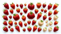 Fresh ripe strawberries collection isolated on white background. Various sizes and angles of red berries with green leaves for healthy food design.