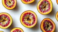 Fresh blood orange halves arranged in rows showing vibrant red flesh and yellow rind on white background, top view composition for food photography and healthy eating concept.