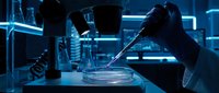 Scientist conducting laboratory experiment with petri dish and pipette in modern research facility with neon blue lighting and advanced equipment.