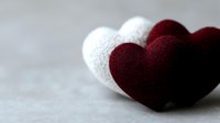 Burgundy and white fabric hearts on neutral background, romantic concept for Valentine's Day, wedding, anniversary or love celebration.