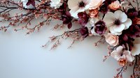 Romantic floral corner arrangement with white anemones, peach roses and burgundy leaves on soft gray background, creating elegant wedding design element.