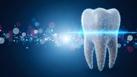 Digital tooth hologram with glowing particles and light effects on blue background for dental technology and healthcare innovation concepts.