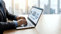Professional businessman using laptop with legal scales justice symbol on screen in modern office environment for law firm consulting services.