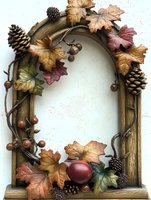 Rustic wooden arch frame decorated with autumn maple leaves, pine cones, and berries creates seasonal border on white background. Suitable for fall designs.