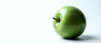 Fresh green apple with stem isolated on white background, suitable for healthy eating, nutrition, and food packaging design projects.