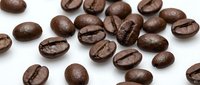 Roasted coffee beans scattered on white background, isolated for design use. Fresh aromatic espresso beans with natural cracks, perfect for cafe branding.
