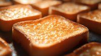 Golden brown toast with melted butter close-up, showing crispy texture and glistening surface for food photography or breakfast menu design.
