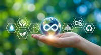 Hand holding glowing Earth with circular economy icons on green bokeh background representing sustainable business and environmental responsibility.
