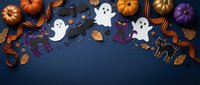 Halloween flat lay with pumpkins, ghosts, black cats and autumn leaves on dark blue background. Festive spooky decoration frame for October holiday celebration.