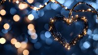 Glowing heart shape made with fairy lights against dark background with soft bokeh lights creating romantic atmosphere for Valentine's Day or wedding decor.